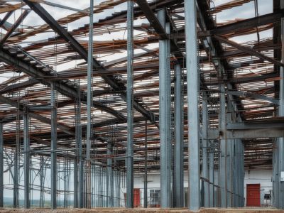 Modern commercial building under construction with visible steel framework and structural beams